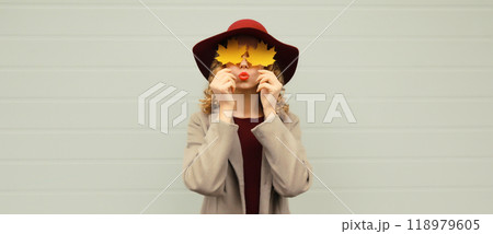 Autumn portrait beautiful happy young woman with yellow maple leaves, stylish joyful girl in hat Autumn portrait beautiful happy young woman with yellow maple leaves, stylish joyful girl in hat 118979605