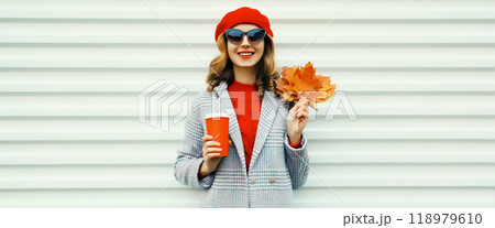 Autumn portrait of beautiful smiling young woman with yellow maple leaves, cup of coffee drink 118979610