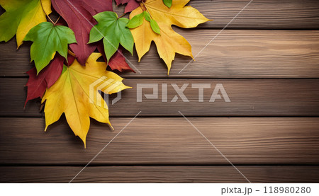 Wooden table with colorful autumn leaves on it creating a frame around the background copy space for advertising text. Top view 118980280