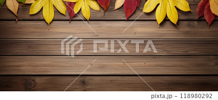 Wooden table with colorful autumn leaves on it creating a frame around the background copy space for advertising text. Top view Wooden table with colorful autumn leaves on it creating a frame around the background copy space for advertising text. Top view 118980292