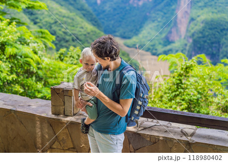 Dad and his baby son travelers exploring Sumidero Canyon National Park, Mexico. Adventure, natural exploration, and travel experience concept Dad and his baby son travelers exploring Sumidero Canyon National Park, Mexico. Adventure, natural exploration, and travel experience concept 118980402