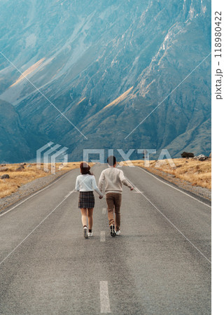 Couple tourist running on the road and rocky mountain background Couple tourist running on the road and rocky mountain background 118980422