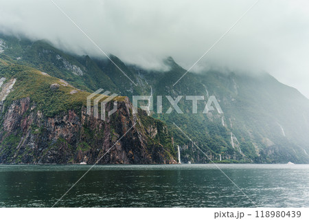 Scenic cruise with natural cascade on mountain in fjord at Milford Sound, New Zealand 118980439
