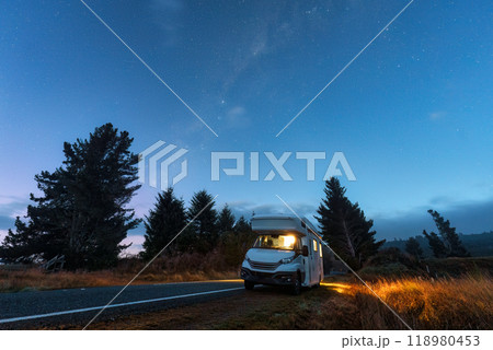 Milky way with starry in night sky and motorhome parked on roadside 118980453