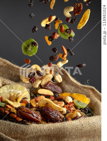 Dried tropical fruits and nuts in burlap bag. Dried tropical fruits and nuts in burlap bag. 118981024