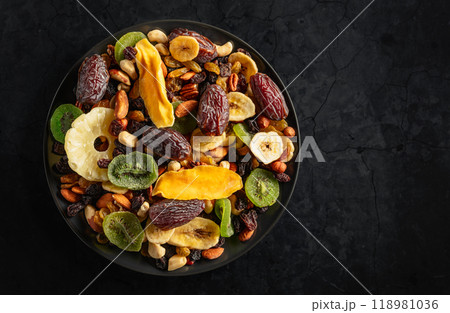 Dried tropical fruits with various nuts and raisins. Dried tropical fruits with various nuts and raisins. 118981036