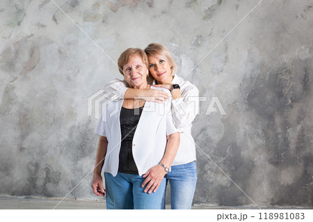 Portrait of elderly woman with her granddaughter Portrait of elderly woman with her granddaughter 118981083