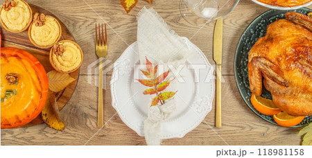 Thanksgiving dinner with tableware autumnal decorations rest with turkey, dressing, sweet potatoes and pie, top view 118981158