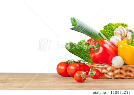 basket with fresh vegetables on wooden table background isolated, Organic vegetables 118981252