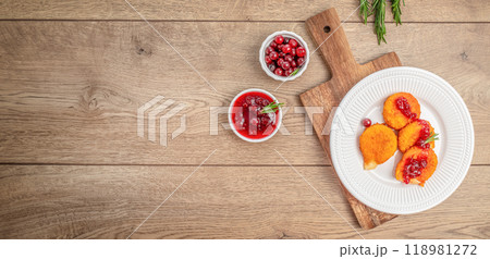 Deep fried camembert nuggets. Baked or fried Camembert or brie cheese with cranberry and sauce Deep fried camembert nuggets. Baked or fried Camembert or brie cheese with cranberry and sauce 118981272