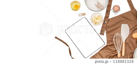digital tablet computer apps with baking ingredients and utensil on kitchen table, top view 118981328