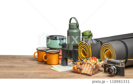 healthy snack of tourists with different camping equipment on a wooden board. food for the trip isolated on white healthy snack of tourists with different camping equipment on a wooden board. food for the trip isolated on white 118981331