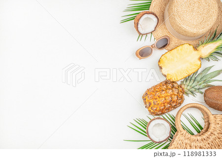 women's summer accessories and tropical fruits pineapple coconut, concept of vacation nutrition, tourism 118981333