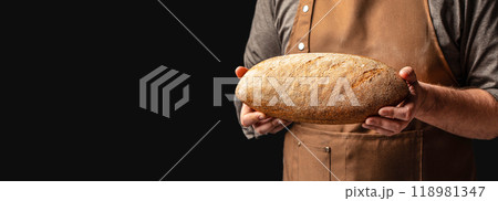Baker man holding whole grain bread. Homemade sourdough bread. Vegan or gluten free diet 118981347