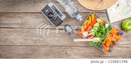 Road trip lunch box filled with of fruits, berries and crunches on white wooden background, snack food travel 118981396