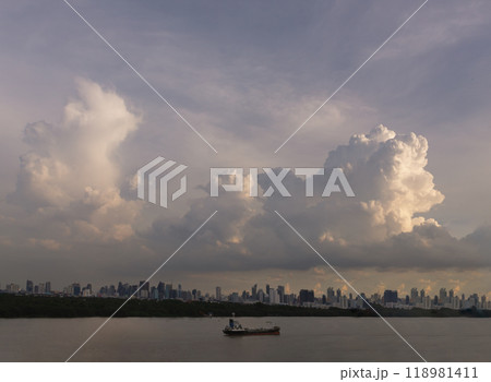 Beautiful Clouds in the Sky over Large Metropolitan City of Bangkok along Chao praya riverside with cargo ship. 118981411