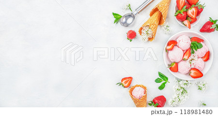 Strawberry ice cream scoop with fresh strawberries and icecream cones on a white background top view. copy space 118981480