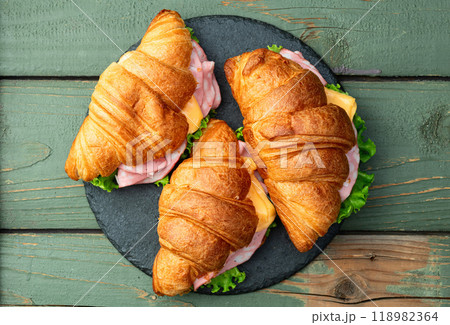 Croissant sandwich with salad ham and cheese . Top view Croissant sandwich with salad ham and cheese . Top view 118982364