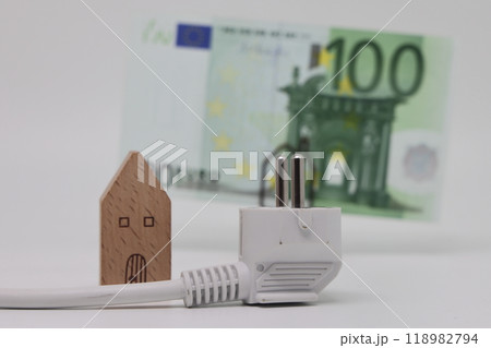 White electric cable and banknotes against the background of a toy model house,  118982794