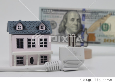 White electric cable and banknotes against the background of a toy model house, 118982796