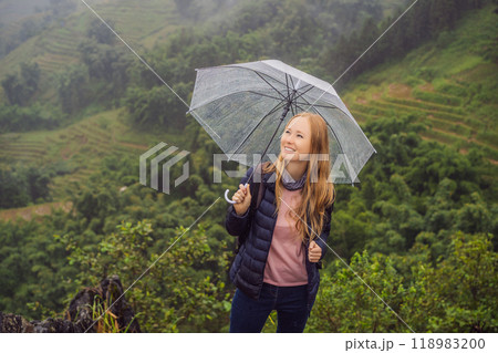 Woman tourist with umbrella in Sapa in the fog, Northwest Vietnam. Vietnam travel concept. UNESCO heritage. Vietnam opens to tourism after quarantine Coronovirus COVID 19 Woman tourist with umbrella in Sapa in the fog, Northwest Vietnam. Vietnam travel concept. UNESCO heritage. Vietnam opens to tourism after quarantine Coronovirus COVID 19 118983200