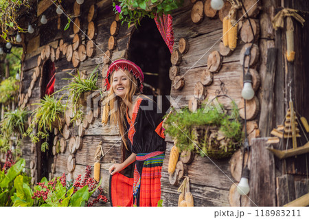 A female tourist dressed in the traditional dress of the inhabitants of the Vietnamese mountains, the Hmong. Woman in Sapa in the fog, Northwest Vietnam. Vietnam travel concept. UNESCO heritage A female tourist dressed in the traditional dress of the inhabitants of the Vietnamese mountains, the Hmong. Woman in Sapa in the fog, Northwest Vietnam. Vietnam travel concept. UNESCO heritage 118983211