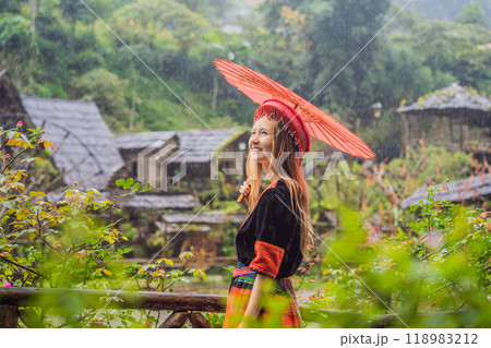 A female tourist dressed in the traditional dress of the inhabitants of the Vietnamese mountains, the Hmong. Woman in Sapa in the fog, Northwest Vietnam. Vietnam travel concept. UNESCO heritage A female tourist dressed in the traditional dress of the inhabitants of the Vietnamese mountains, the Hmong. Woman in Sapa in the fog, Northwest Vietnam. Vietnam travel concept. UNESCO heritage 118983212