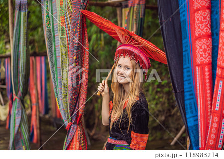 A female tourist dressed in the traditional dress of the inhabitants of the Vietnamese mountains, the Hmong. Woman in Sapa in the fog, Northwest Vietnam. Vietnam travel concept. UNESCO heritage A female tourist dressed in the traditional dress of the inhabitants of the Vietnamese mountains, the Hmong. Woman in Sapa in the fog, Northwest Vietnam. Vietnam travel concept. UNESCO heritage 118983214