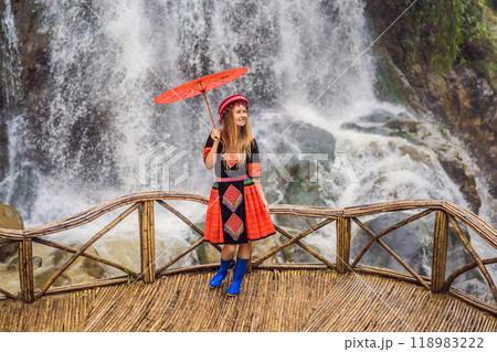 A female tourist dressed in the traditional dress of the inhabitants of the Vietnamese mountains, the Hmong. Woman in Sapa in the fog, Northwest Vietnam. Vietnam travel concept. UNESCO heritage A female tourist dressed in the traditional dress of the inhabitants of the Vietnamese mountains, the Hmong. Woman in Sapa in the fog, Northwest Vietnam. Vietnam travel concept. UNESCO heritage 118983222