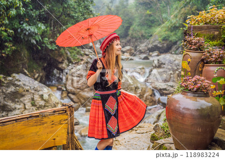 A female tourist dressed in the traditional dress of the inhabitants of the Vietnamese mountains, the Hmong. Woman in Sapa in the fog, Northwest Vietnam. Vietnam travel concept. UNESCO heritage A female tourist dressed in the traditional dress of the inhabitants of the Vietnamese mountains, the Hmong. Woman in Sapa in the fog, Northwest Vietnam. Vietnam travel concept. UNESCO heritage 118983224