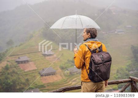 Man tourist with umbrella in Sapa in the fog, Northwest Vietnam. Vietnam travel concept. UNESCO heritage. Vietnam opens to tourism after quarantine Coronovirus COVID 19 Man tourist with umbrella in Sapa in the fog, Northwest Vietnam. Vietnam travel concept. UNESCO heritage. Vietnam opens to tourism after quarantine Coronovirus COVID 19 118983369