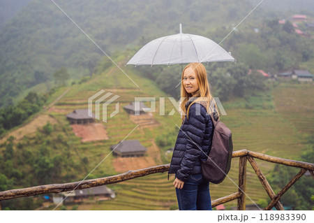 Woman tourist with umbrella in Sapa in the fog, Northwest Vietnam. Vietnam travel concept. UNESCO heritage. Vietnam opens to tourism after quarantine Coronovirus COVID 19 Woman tourist with umbrella in Sapa in the fog, Northwest Vietnam. Vietnam travel concept. UNESCO heritage. Vietnam opens to tourism after quarantine Coronovirus COVID 19 118983390