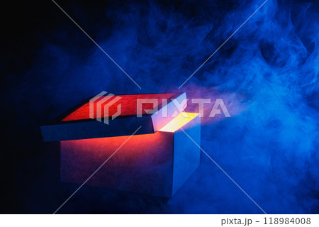 Man opens magic box with surprise on dark background, mystical box, surprise, halloween, monster box Man opens magic box with surprise on dark background, mystical box, surprise, halloween, monster box 118984008