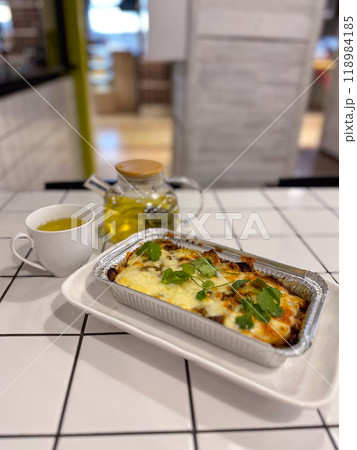 Traditional Greek moussaka with beef mince, eggplant and bechamel sauce in cafe Traditional Greek moussaka with beef mince, eggplant and bechamel sauce in cafe 118984185