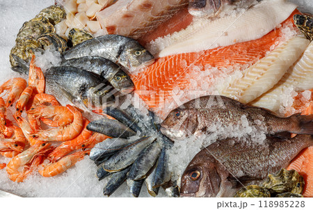 An enticing Fresh Seafood Display, beautifully arranged on ice and showcasing a variety of fish An enticing Fresh Seafood Display, beautifully arranged on ice and showcasing a variety of fish 118985228