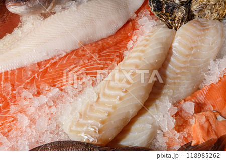 Explore a stunning display of a diverse variety of fresh seafood on ice at the market Explore a stunning display of a diverse variety of fresh seafood on ice at the market 118985262