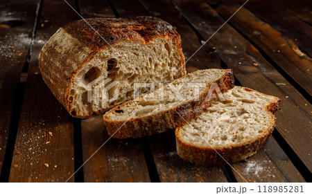 Freshly Baked Artisan Bread Beautifully Displayed on a Rustic Wooden Table Surface 118985281