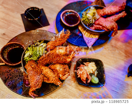 Thai style fried chicken with spicy sauce on wooden table in restaurant 118985725
