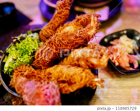 Thai style fried chicken with spicy sauce on wooden table in restaurant 118985729