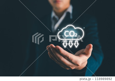 Reduce CO2 and Net zero emissions concept. Climate change to limit global warming and sustainable development and green business. CO2 reduction on businessman hand for save world carbon neutral. Reduce CO2 and Net zero emissions concept. Climate change to limit global warming and sustainable development and green business. CO2 reduction on businessman hand for save world carbon neutral. 118989892