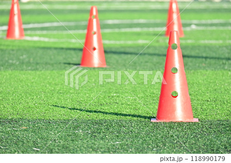 artificial green grass soccer field with orange training cones artificial green grass soccer field with orange training cones 118990179