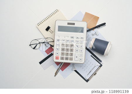 A calculator, financial documents, eyeglasses and other office supplies on white background 118991139