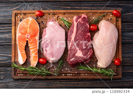Mix of raw meat and fish . Salmon , beef , pork , chicken staek . Top view 118992334