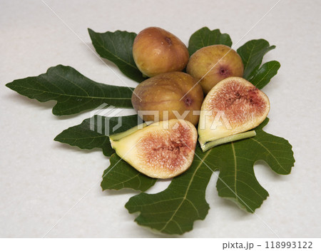 Fresh fig with leave on white mat. Fresh fig with leave on white mat. 118993122