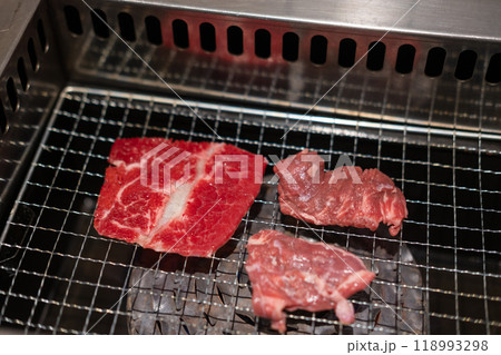 Korean Style Barbecue on stainless grill. BBQ rare meat with soft focus Korean Style Barbecue on stainless grill. BBQ rare meat with soft focus 118993298