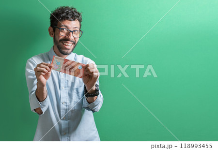 Happy person showing you a single bill. Friendly man with a smile showing one money bill isolated, Concept of person showing a 500 Nicaraguan cordobas bill. 118993455