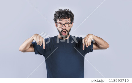 Amazed man pointing down isolated, Shocked person pointing down with fingers isolated, Amazed young man pointing down Amazed man pointing down isolated, Shocked person pointing down with fingers isolated, Amazed young man pointing down 118993710