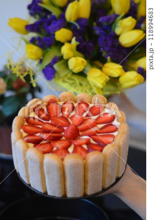 Homemade birthday cake with strawberries and a bouquet of flowers Homemade birthday cake with strawberries and a bouquet of flowers 118994683