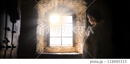 Young girl at old window 118995315
