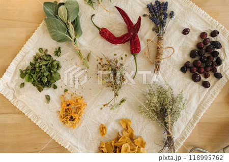 Top view of dried herbs and seasonings on linen tablecloth. Healthy homemade and natural. Red hot pepper.  118995762